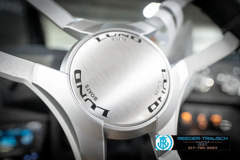 Slide: The Image of Steering wheel of 2026 Lund 2275 Baron boat, featuring sleek metallic design. - 37