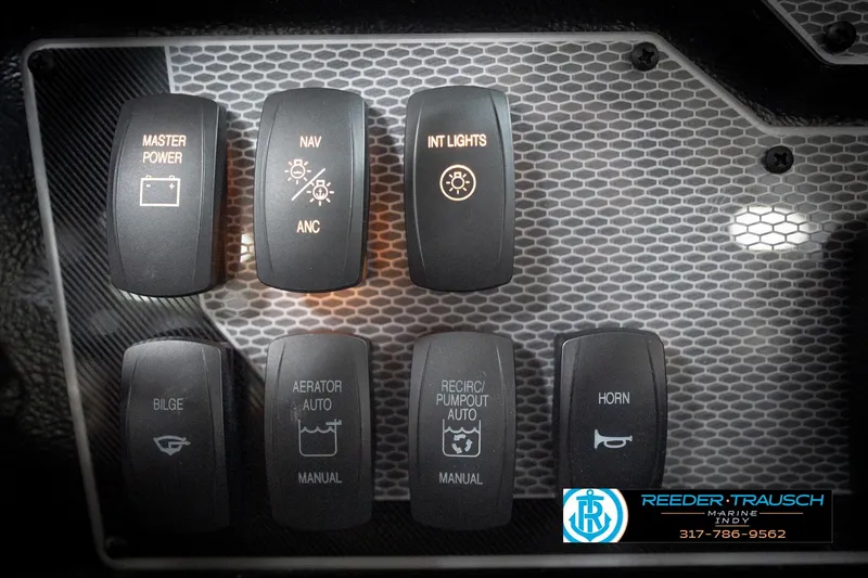 Slide: The Image of Control panel of 2026 Lund 2275 Baron boat with various switches and labels. - 40