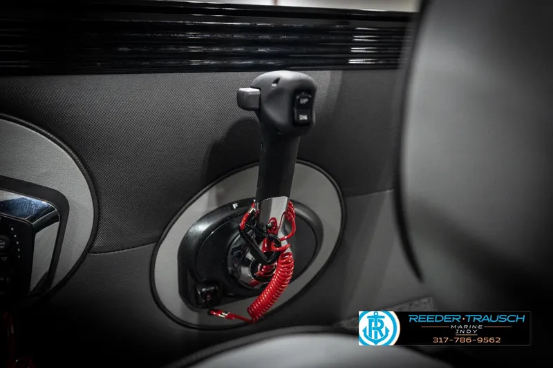 Slide: The Image of 2026 Lund 2275 Baron boat throttle control with red safety cord, Reeder-Trausch Marine branding. - 43