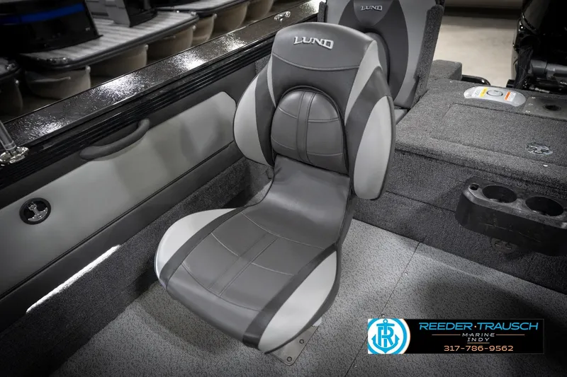 Slide: The Image of 2026 Lund 2275 Baron boat interior with gray seating and cup holders. - 46