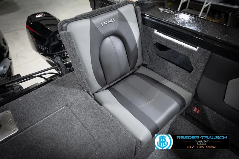 Slide: The Image of 2026 Lund 2275 Baron boat interior with gray seating and motor detail. - 47