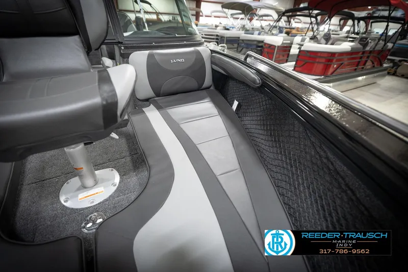 Slide: The Image of 2026 Lund 2275 Baron boat interior with gray seating and sleek design. - 49