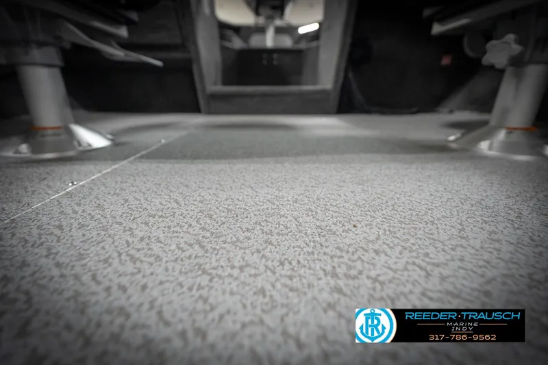 Slide: The Image of 2026 Lund 2275 Baron boat interior flooring, featuring textured surface and seating mounts. - 53