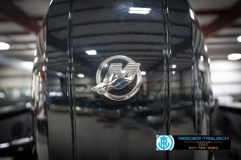 Slide: The Image of Close-up of 2026 Lund 2275 Baron boat engine with logo in a showroom. - 57