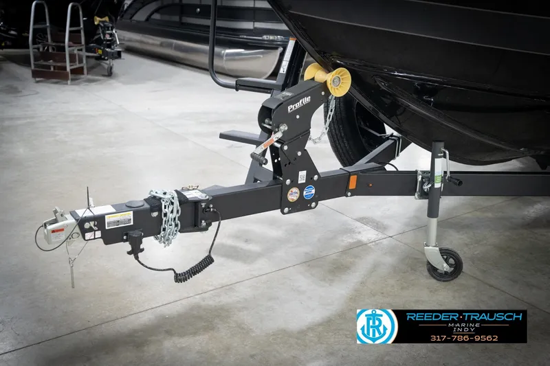 Slide: The Image of Trailer hitch of 2026 Lund 2275 Baron boat in showroom setting. - 65