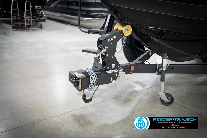 Slide: The Image of Trailer hitch of 2026 Lund 2275 Baron boat in showroom setting. - 66