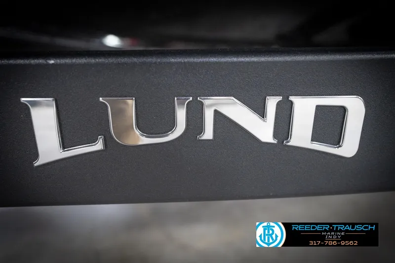 Slide: The Image of Chrome "Lund" logo on 2026 Lund 2275 Baron boat, Reeder-Trausch Marine branding. - 67