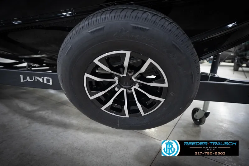 Slide: The Image of 2026 Lund 2275 Baron trailer wheel with sleek black and silver design. - 68