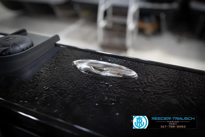 Slide: The Image of 2026 Lund 2275 Baron boat detail with textured surface and chrome handle. - 69