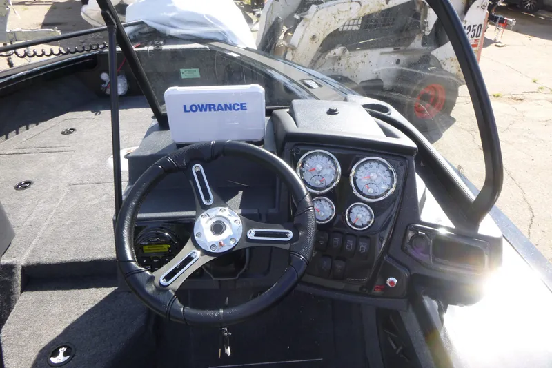 Slide: The Image of 2026 Tracker Targa V-19 WT boat dashboard with steering wheel and Lowrance navigation system. - 13