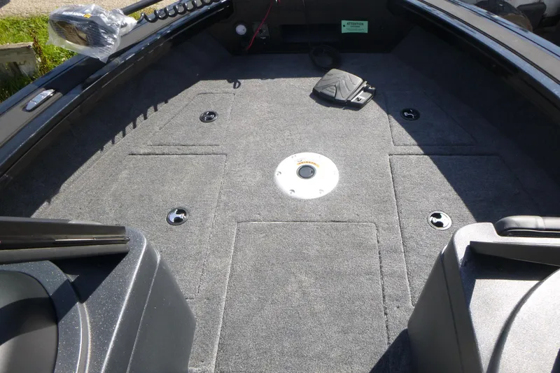 Slide: The Image of 2026 Tracker Targa V-19 WT boat interior with carpeted deck and storage compartments. - 7