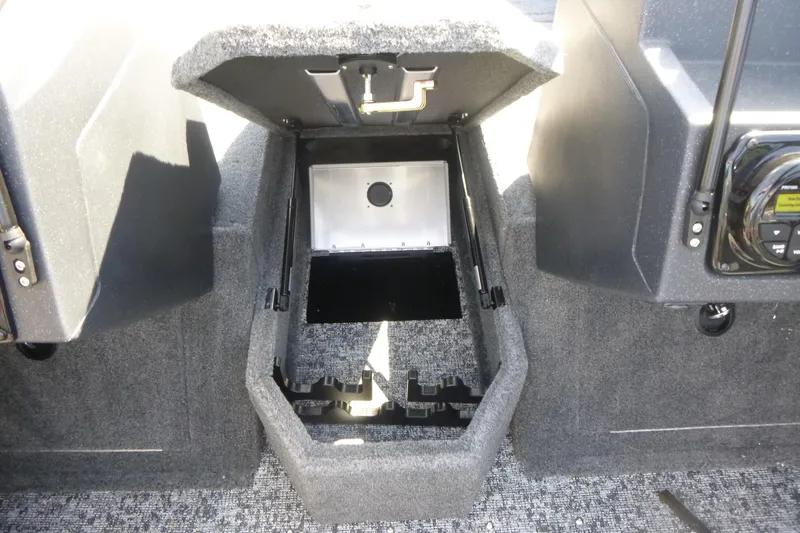 Slide: The Image of 2026 Tracker Targa V-19 WT boat storage compartment with open lid, showcasing interior space. - 9