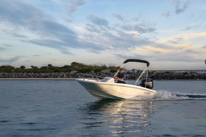 Slide: The Image of 2026 Boston Whaler 130 Super Sport cruising on calm waters at sunset. - 0