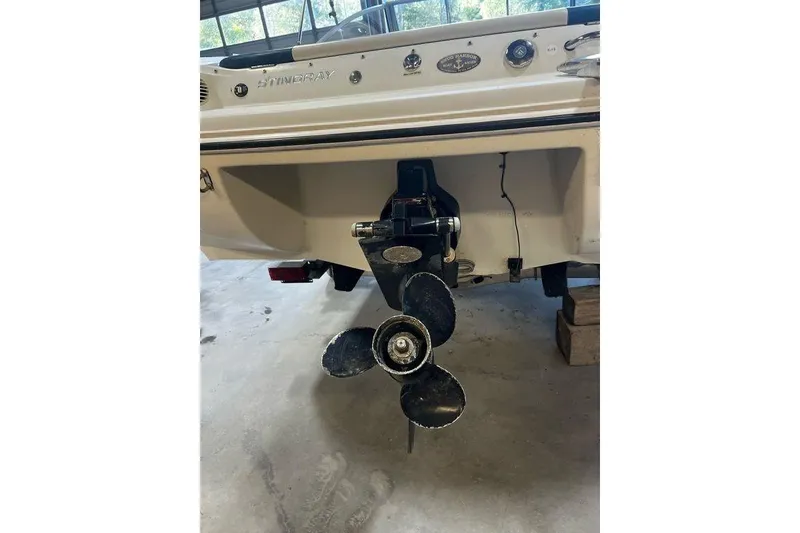 Slide: The Image of Rear view of a 2013 Stingray 195RX boat showing the propeller and stern details. - 11