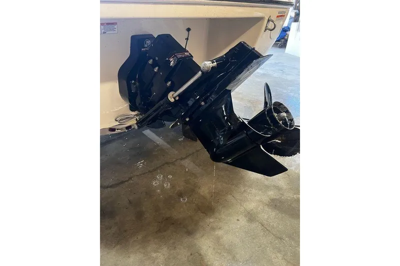 Slide: The Image of 2013 Stingray 195RX boat outboard motor in a garage setting. - 14