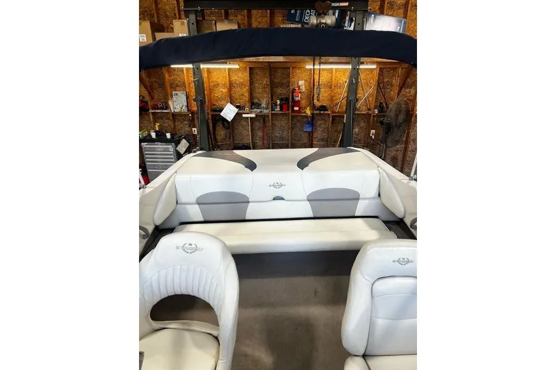 Slide: The Image of Interior of a 2013 Stingray 195RX boat with white and gray seating. - 16