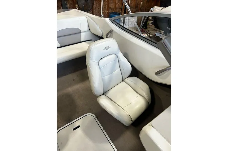 Slide: The Image of 2013 Stingray 195RX boat interior with white leather seating and dashboard view. - 17
