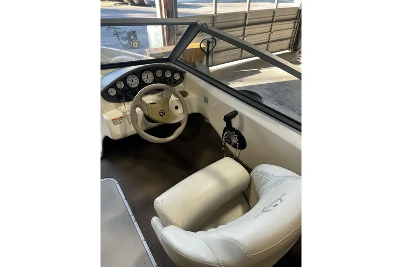 Slide: The Image of Interior view of 2013 Stingray 195RX boat cockpit with steering wheel and controls. - 22