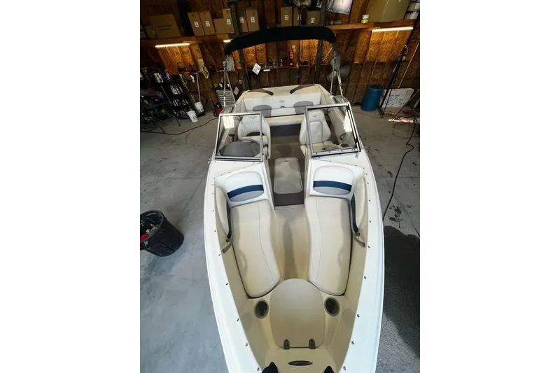 Slide: The Image of 2013 Stingray 195RX boat interior in a garage setting. - 3