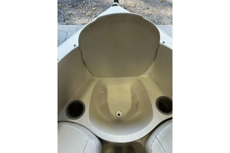 Slide: The Image of Interior of a 2013 Stingray 195RX boat, featuring seating and cup holders. - 5