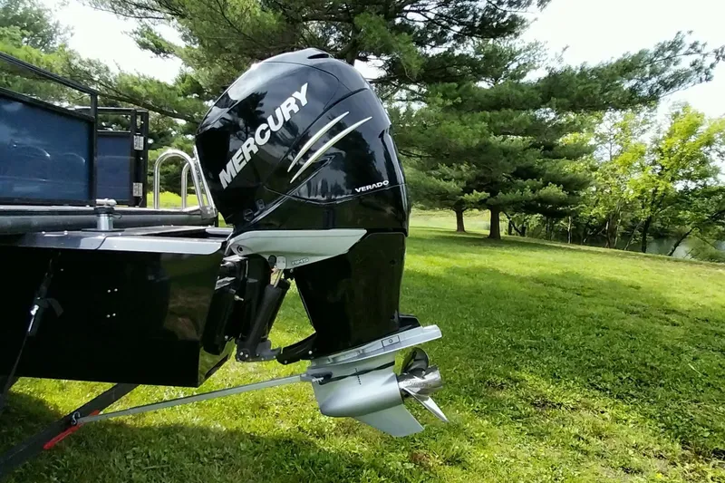 Slide: The Image of 2022 Regency 250 DL3 boat with Mercury Verado engine in a grassy area. - 12