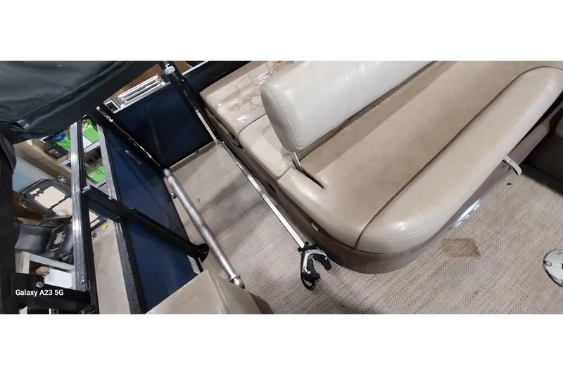 Slide: The Image of 2022 Regency 250 DL3 boat interior with beige seating and carpeted floor. - 17