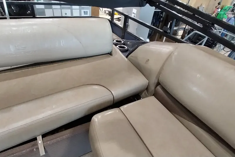 Slide: The Image of 2022 Regency 250 DL3 boat interior with beige seating and cup holders. - 18