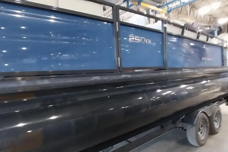 Slide: The Image of 2022 Regency 250 DL3 pontoon boat in a showroom setting. - 21