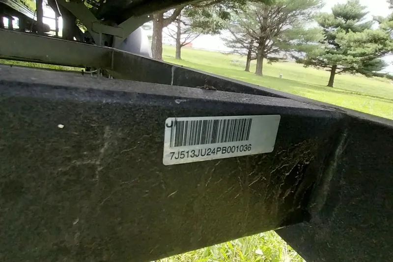 Slide: The Image of Barcode on 2022 Regency 250 DL3 boat frame, surrounded by trees and grass. - 26