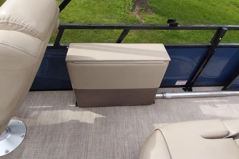 Slide: The Image of 2022 Regency 250 DL3 boat interior with beige seating and storage compartment. - 6