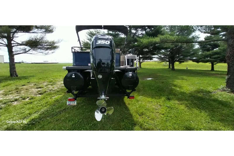 Slide: The Image of 2022 Regency 250 DL3 boat with 350 engine on grassy field. - 8