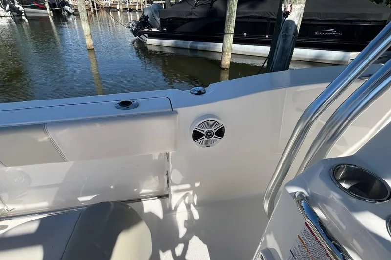 Slide: The Image of 2017 Robalo R200 Center Console boat interior with speaker and railing, docked at marina. - 21