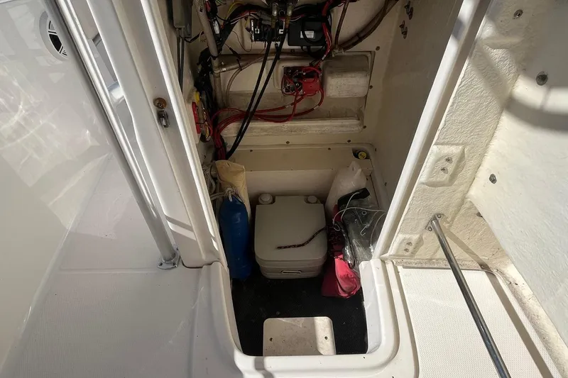Slide: The Image of 2017 Robalo R200 Center Console storage compartment with wiring and equipment. - 22