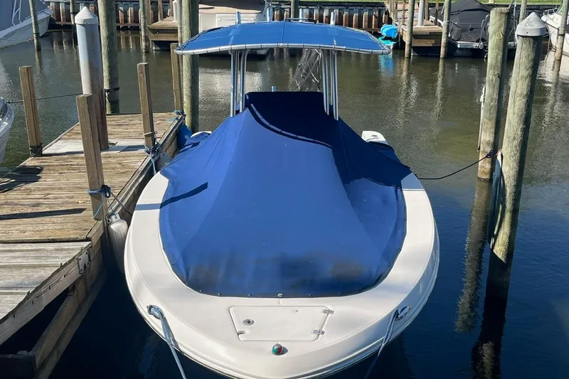 Slide: The Image of 2017 Robalo R200 Center Console boat docked with blue cover. - 3