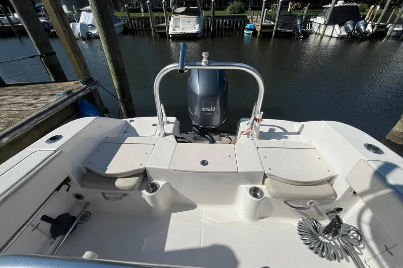 Slide: The Image of 2017 Robalo R200 Center Console boat docked, featuring a 150 horsepower engine. - 8
