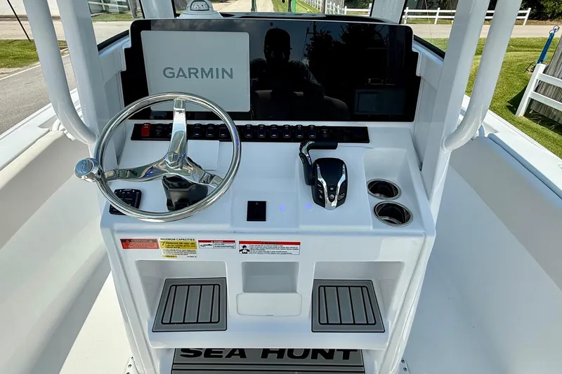 Slide: The Image of 2026 Sea Hunt Ultra 245 SE boat console with Garmin display and steering wheel. - 10