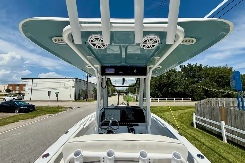 Slide: The Image of 2026 Sea Hunt Ultra 245 SE boat with T-top and Garmin navigation system on a sunny day. - 11