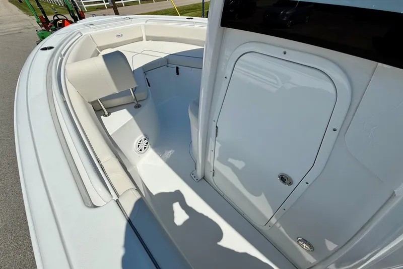 Slide: The Image of 2026 Sea Hunt Ultra 245 SE boat interior with seating and storage compartment. - 12