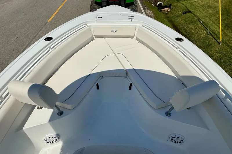 Slide: The Image of 2026 Sea Hunt Ultra 245 SE boat interior with cushioned seating and cup holders. - 14