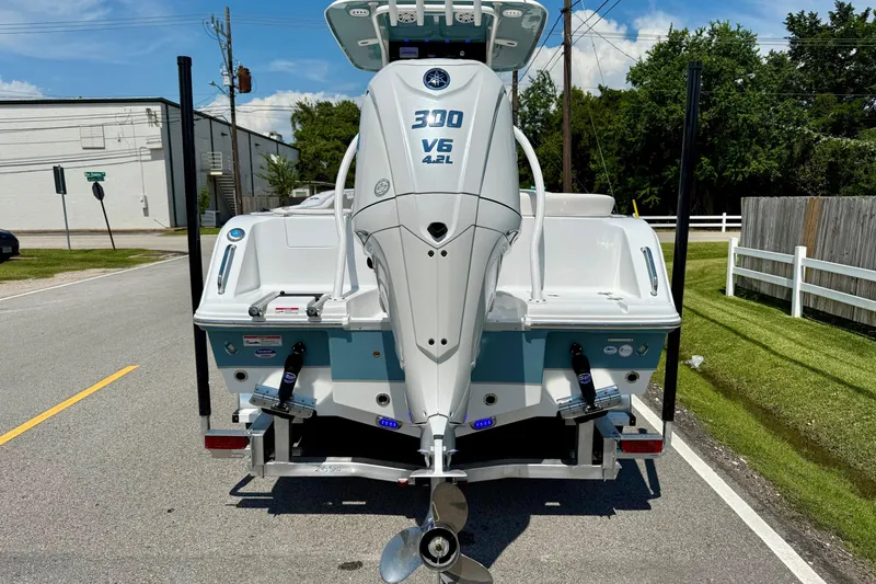 Slide: The Image of 2026 Sea Hunt Ultra 245 SE boat with powerful V6 engine on a sunny street. - 3