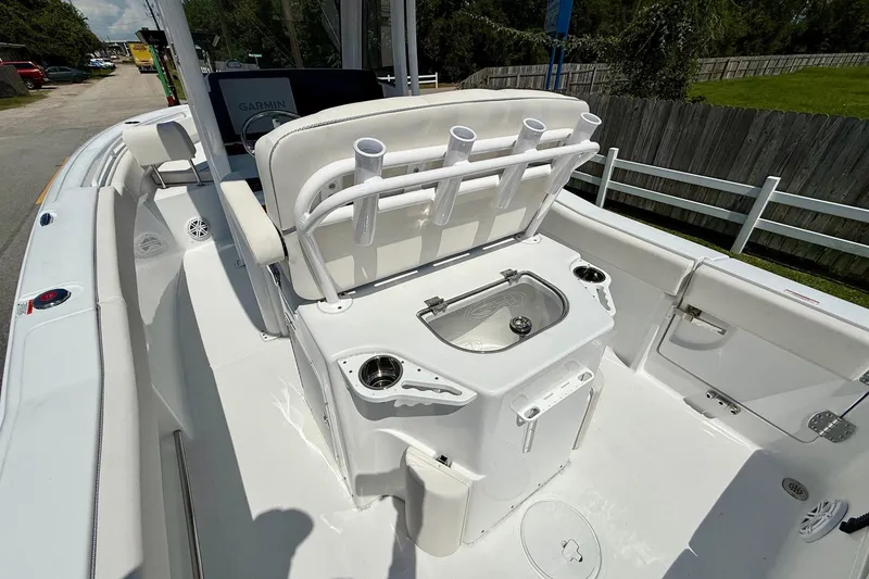 Slide: The Image of 2026 Sea Hunt Ultra 245 SE boat interior with rod holders and storage compartments. - 8