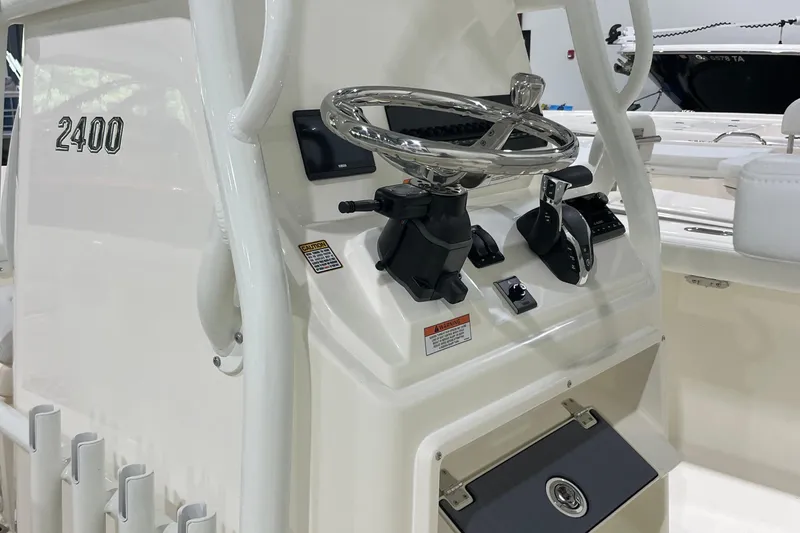 Slide: The Image of 2026 Pathfinder 2400 TRS boat console with steering wheel and controls. - 19