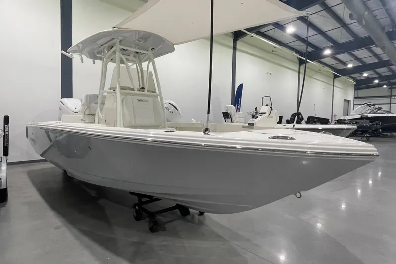 Slide: The Image of 2026 Pathfinder 2400 TRS boat displayed in a spacious indoor showroom. - 26