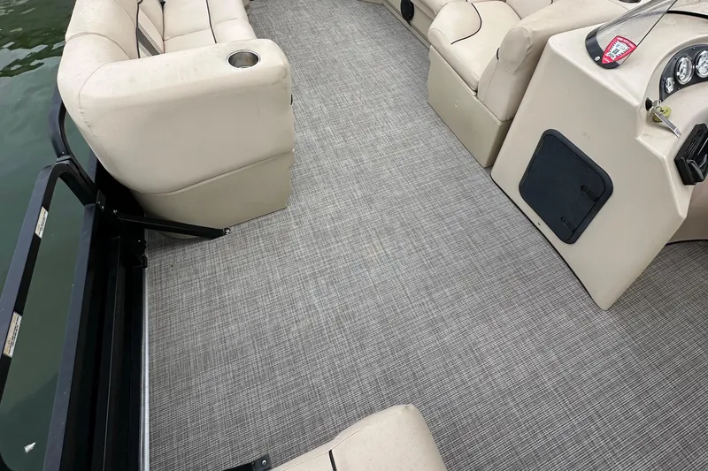 Slide: The Image of 2011 Bentley Pontoons 240 CRUISE interior with beige seating and gray flooring. - 4