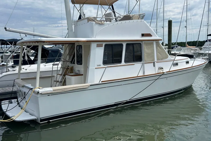 The Image of 2004 Sabre 36 FB yacht docked at marina, featuring classic design and spacious deck. - 0