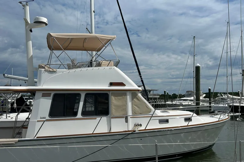 Slide: The Image of 2004 Sabre 36 FB yacht docked at marina under cloudy sky. - 1