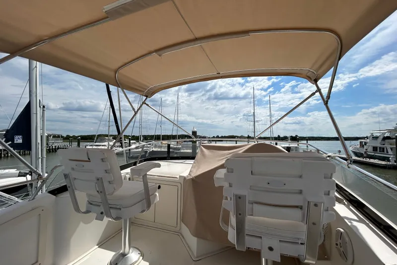 Slide: The Image of Flybridge of 2004 Sabre 36 FB yacht with seating, overlooking marina and sky. - 10