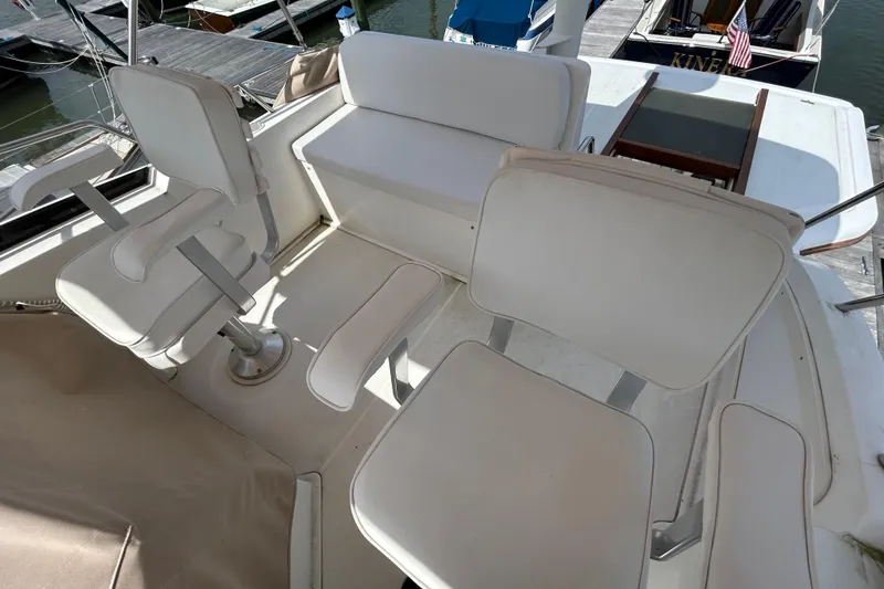 Slide: The Image of 2004 Sabre 36 FB boat interior with white seating and dock view. - 11
