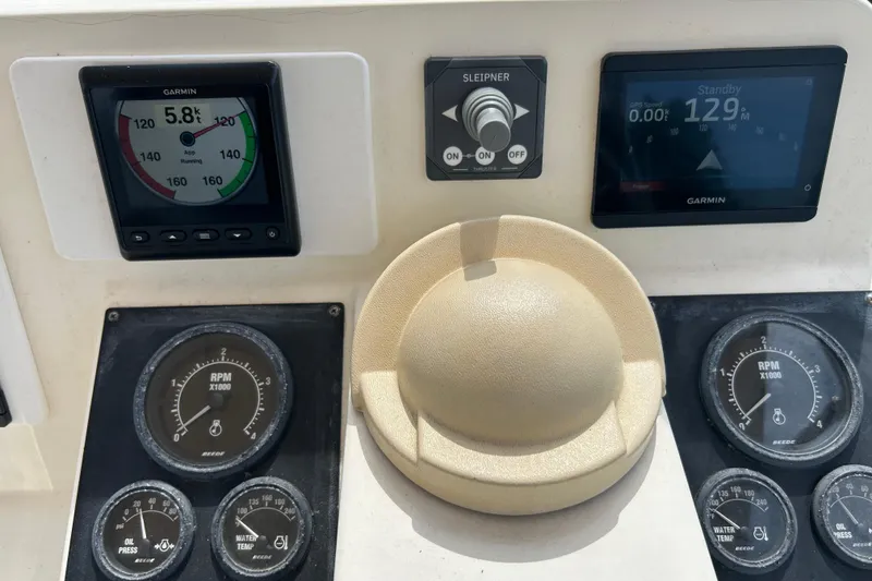 Slide: The Image of Control panel of a 2004 Sabre 36 FB boat with Garmin displays and gauges. - 12