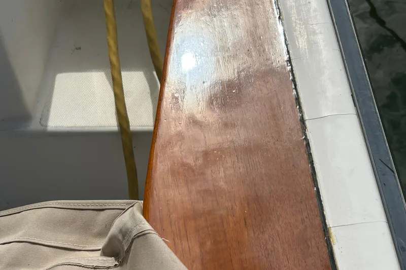 Slide: The Image of Polished wooden deck of 2004 Sabre 36 FB boat with sunlight reflection. - 15